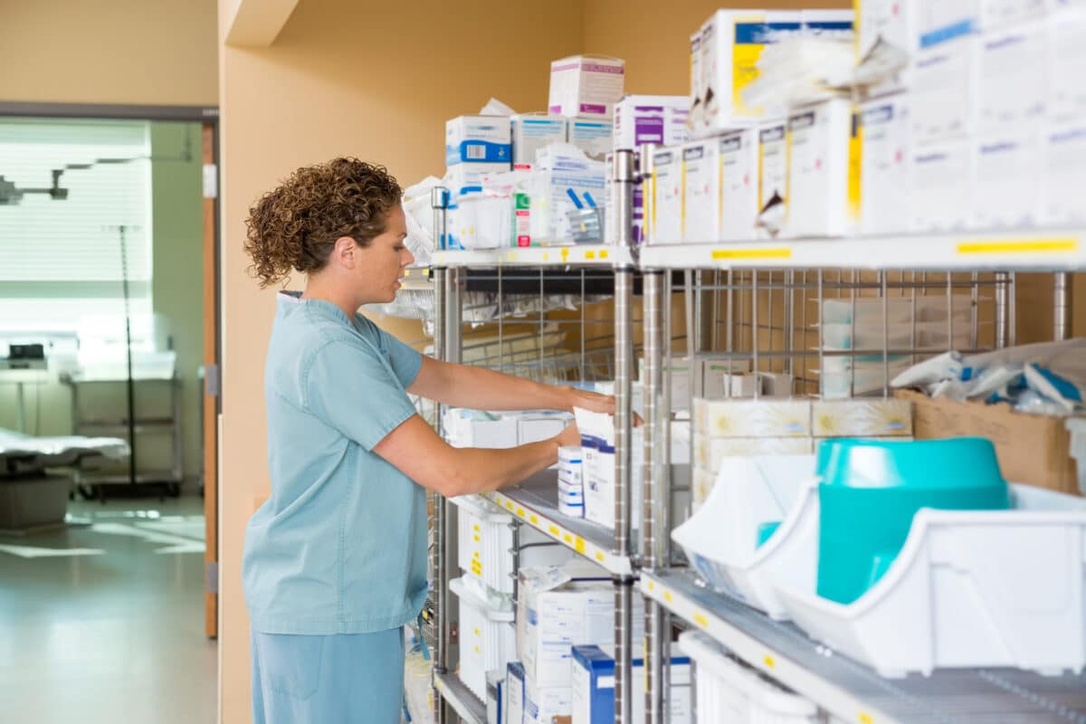 Nurse chooses supplies in storage closet