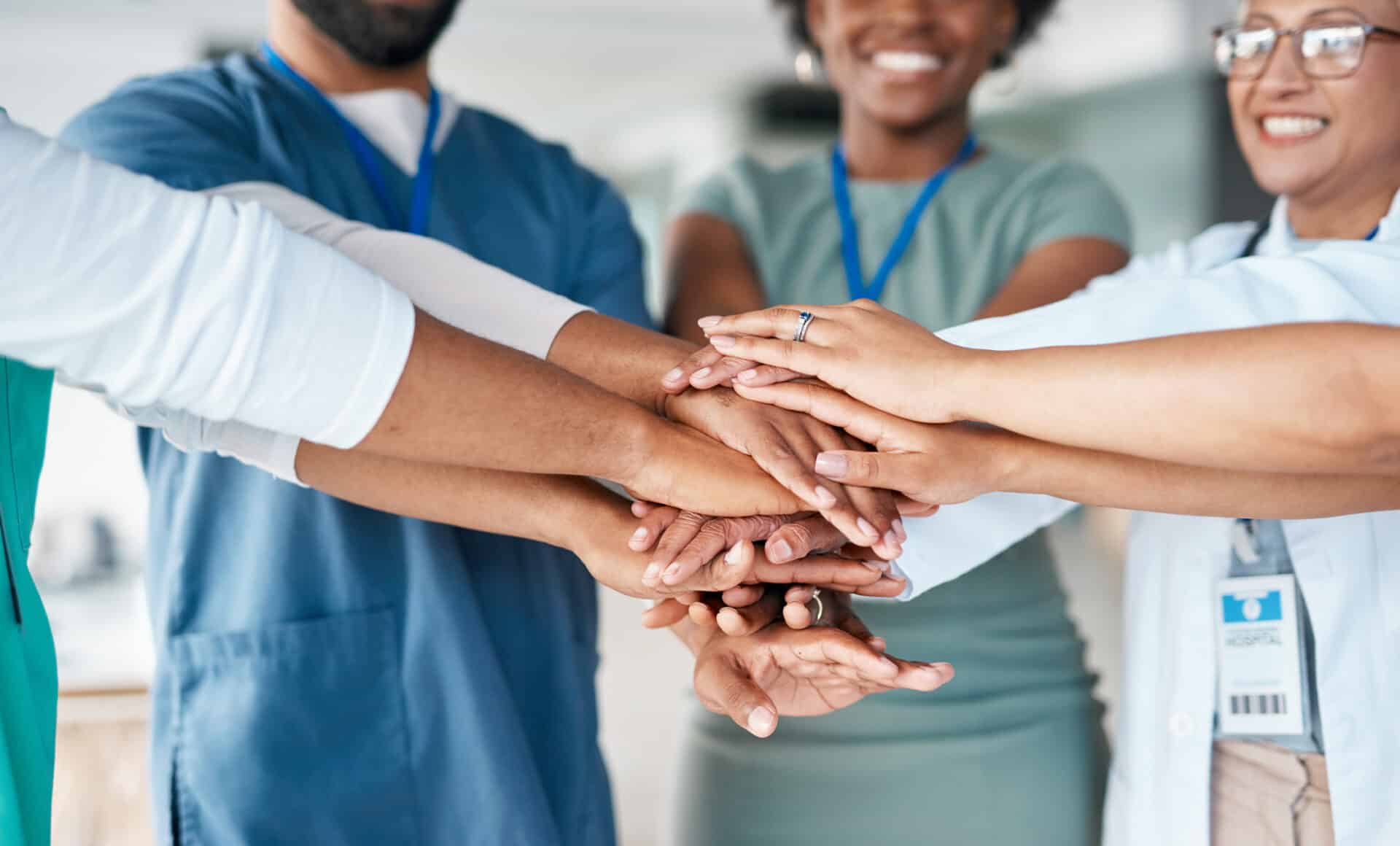 Hands together of doctors and nurses in healthcare teamwork, solidarity and support in hospital diversity. Workflow of medical people, staff or employees in hand stack goal for happy clinic workforce